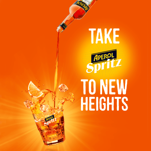 Aperol Spritz drink being poured into a glass.