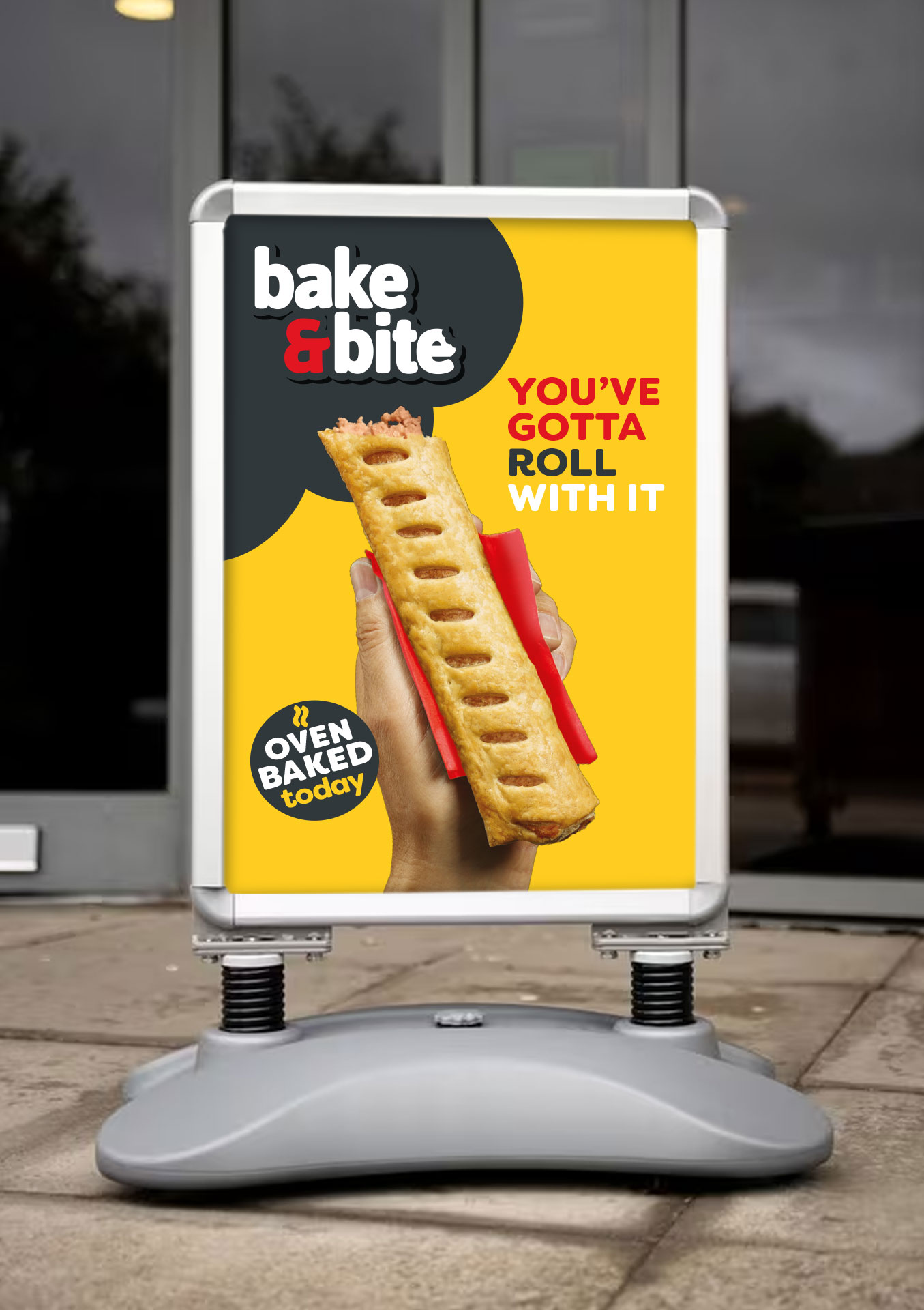 Bake & Bite sausage roll advertisement outside shop