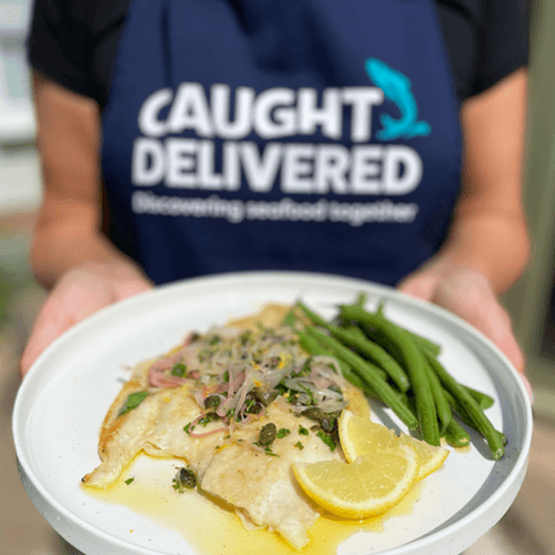 Grilled fish with lemon and green beans served